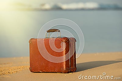 Travel vintage suitcase is alone on a beach Stock Photo