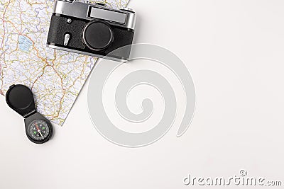 Traveler accessories. Map with old vintage camera and compas isolated on white background with empty space for text Stock Photo