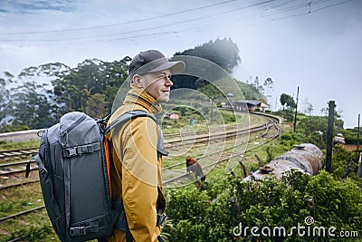 Traveler against train station in clouds Stock Photo