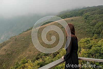 Traveler asia woman look out at viewpoint on the woooden fence on Mountain Kew Mae Pan Doi Inthanon Chiang Mai Editorial Stock Photo