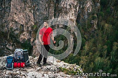 A traveler with a backpack in the mountains. A man with a backpack. The concept of a hiking lifestyle. Hiking in the mountains Stock Photo