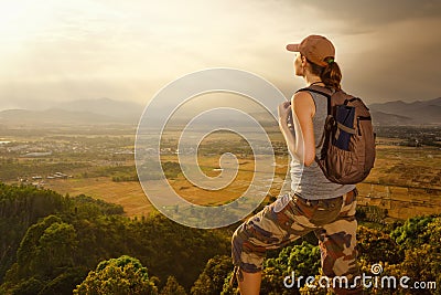 Traveler with backpack relaxing on top of mountain and enjoying Stock Photo