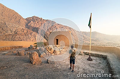 Traveler exploring Dhayah Fort in north Ras Al Khaimah United Arab Emirates at sunset Stock Photo