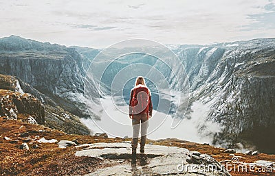 Traveler exploring mountains alone hiking with backpack Stock Photo