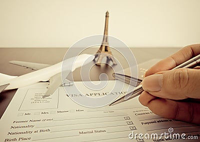 Traveler is filling the Visa form to travel to paris Stock Photo