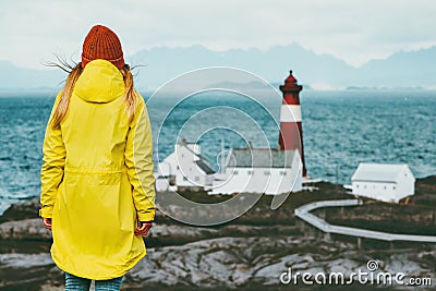 Traveler girl enjoying Norway lighthouse sea landscape Travel Lifestyle concept adventure scandinavian Stock Photo