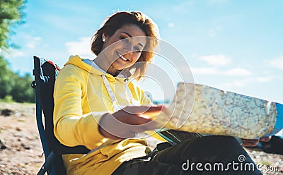 Traveler girl smiling looking on map, vacation trip, happy people planning trip, hipster tourist on nature, enjoy lifestyle Stock Photo
