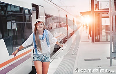 Traveler girl waits train on railway platform with a map and she Stock Photo