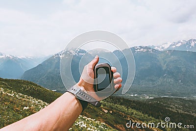 Traveler hand holding gps navigator tracker looking for location coordinates Stock Photo