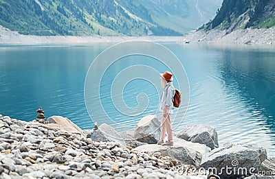 Traveler look at the mountain lake. Travel and active life concept. Adventure and travel in the mountains region in the Austria. Stock Photo