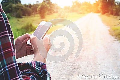 Traveler Man holding and using smartphone. travel concept vintage tone Stock Photo