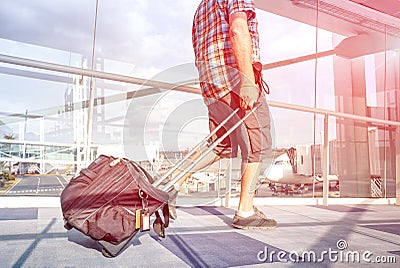 Traveler man at international airport moving to terminal gate Stock Photo
