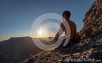 Traveler meditate on mountain Stock Photo
