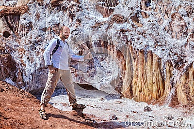 Traveler posing for a photograph near the salty glacier, Iran. Stock Photo