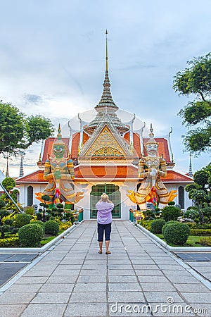 Traveler selfie and take a photo two statue giant at churches Wat Arun, Bangkok, Thailand Stock Photo