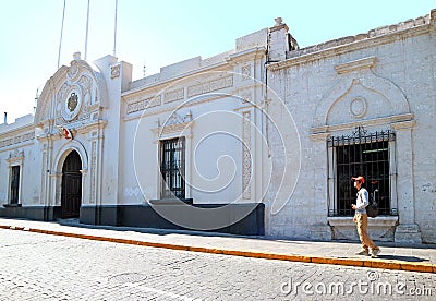 Traveler standing in front of White Sillar Stone Vintage Buildings of the Old City of Arequipa, Peru Stock Photo