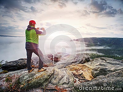 Traveler taking vacation mobile photos of beautiful sunset in autumn nature Stock Photo