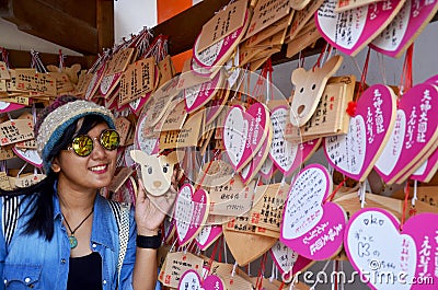 Traveler thai woman posing for shooting photo with Ema Wood tag Editorial Stock Photo