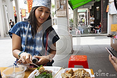 Traveler thai women eating chinese street food Fried Tofu with vegetables and sweet sauce at restaurant of old town at Chaozhou Editorial Stock Photo