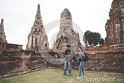 Traveler and tourist asian man and women with backpack walking in temple Ayuttaya ,Thailand. Stock Photo