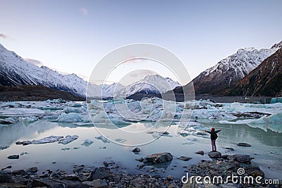 A traveler viewing the icebergs and snow mountains New Zealand Stock Photo