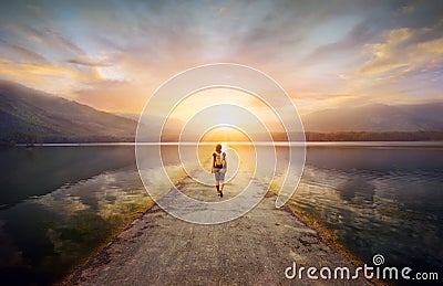 Traveler walking along the road to the mountains Stock Photo