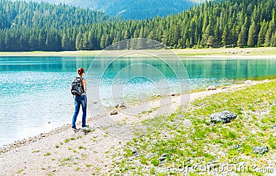 Traveler is walking on the lake coast Stock Photo