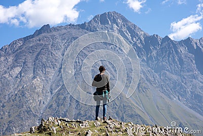 A traveler watching on mountain landscape, Kazbeg mountain - Kazbegi (Stepantsminda), Georgia Stock Photo