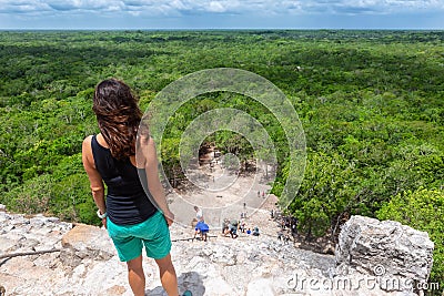 Traveler woman looks the Nohoch Mul pyramid in Coba, Yucatan, Mexico Stock Photo
