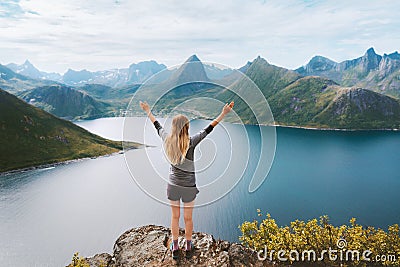 Traveler woman in Norway hiking success raised arms on the top of mountain Travel adventure active vacations outdoor Stock Photo