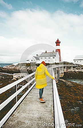 Traveler woman walking on bridge at Norway lighthouse Stock Photo