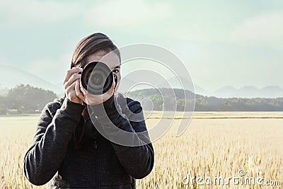 Young taking photograph with rice fields background Stock Photo