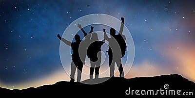 Travelers celebrating success over night sky Stock Photo