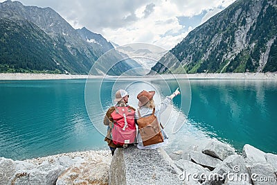 Travelers couple look at the mountain lake. Travel and active life concept with team. Adventure and travel in the mountains region Stock Photo