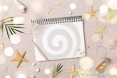 Travelers notebook with accessories on sand background top view. Planning summer holidays, trip and vacation concept. Flat lay Stock Photo