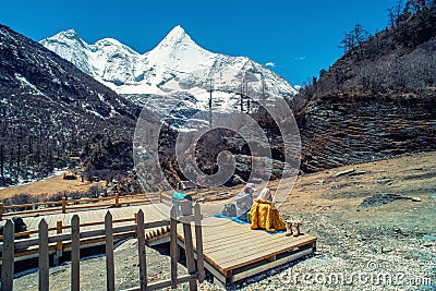 Travelers relaxing with snow capped mountain background to Milk Lake and Five colors lake in Yading Nature Reserve Editorial Stock Photo