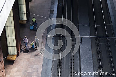Travelers with suitcases walk around Antwerp Railway Station Editorial Stock Photo