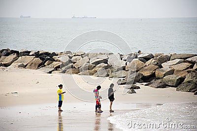 Travelers thai people walking relax on Saeng Chan Beach in Rayong, Thailand Editorial Stock Photo