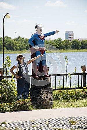 Travelers thai woman posing for take photo with superman thai style Editorial Stock Photo