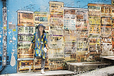 Travelers thai woman travel visit and posing for take photo with the art wall at Hollywood street in Hong Kong, China Editorial Stock Photo