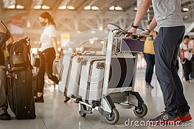 Travelers are walking to drag luggage in modern airport terminal to travel to new places. Editorial Stock Photo