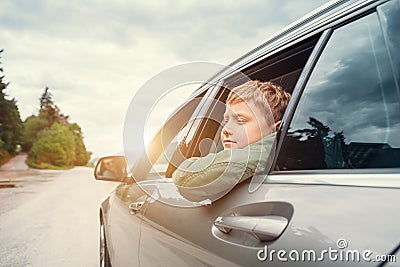 Traveling by auto - son and father look out from car windows Stock Photo