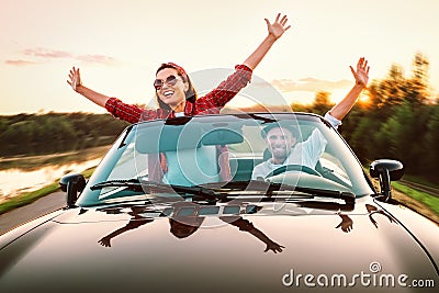 Traveling by car - happy couple in love go by cabriolet car in s Stock Photo