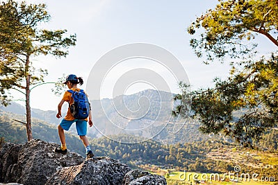 Traveling child. tourist with a backpack goes along a mountain path. hiking and active healthy lifestyle Stock Photo