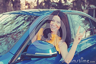 Traveling with fun. Happy woman enjoying road park trip in her new car Stock Photo