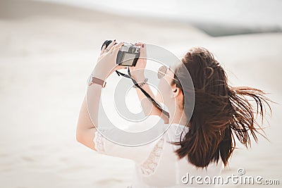 Traveling and photography. Young woman with camera taking photo. Stock Photo