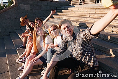 Group of friends taking selfie at camera in city Stock Photo