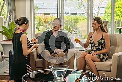 Traveller couple being served with welcome drink from asian hotel reception Stock Photo