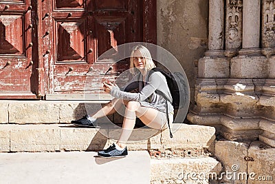 Traveller female watching the city map on the phone. Stock Photo