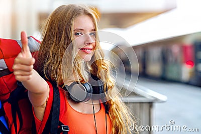 Traveller girl female backpack and tourism outfit at railway station Stock Photo